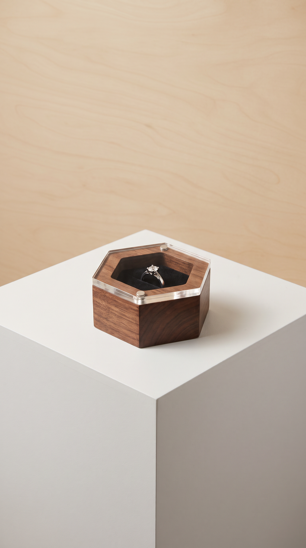 Wood ring box in black walnut with clear acrylic lid, holding a dark ring