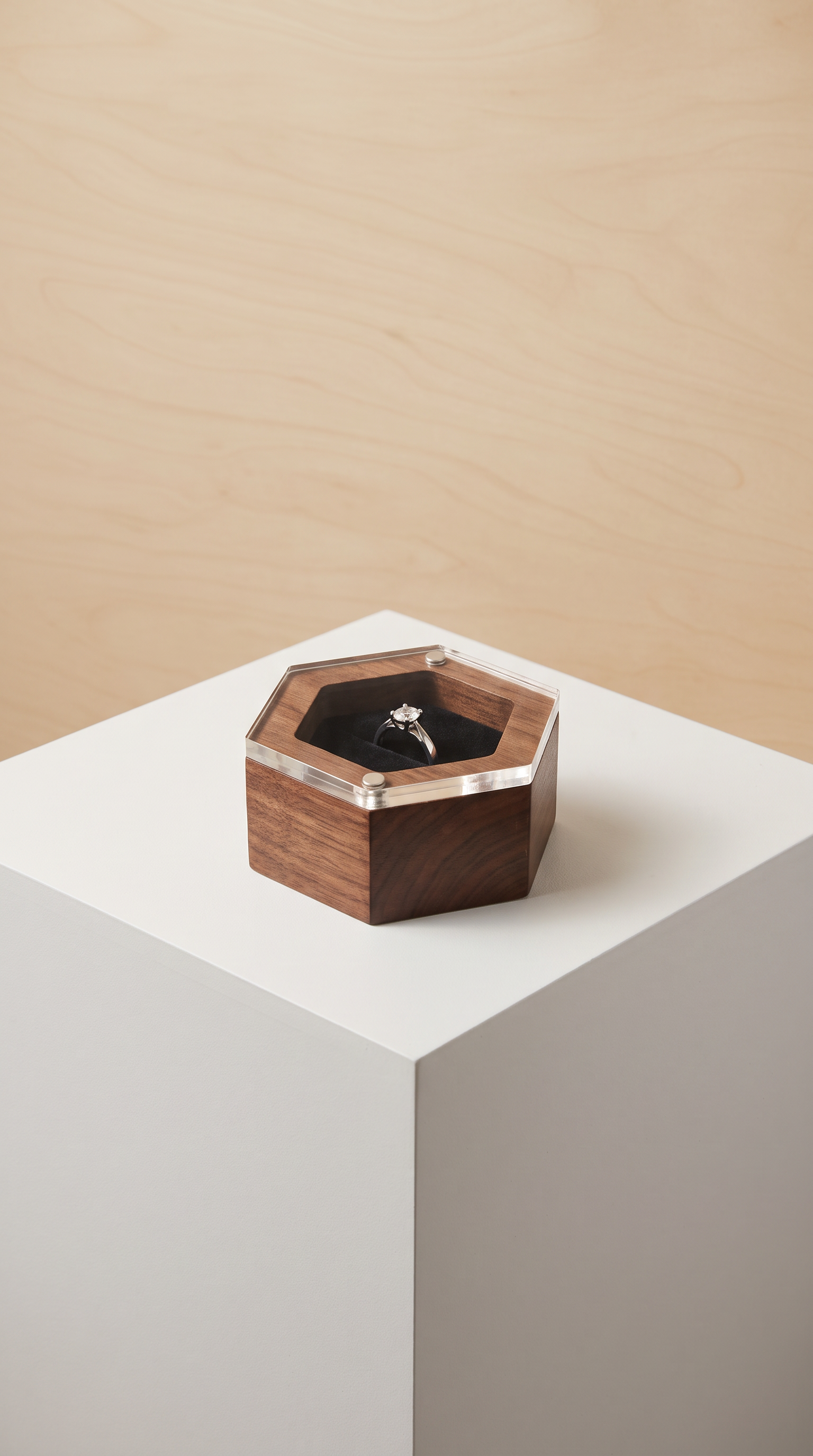 Wood ring box in black walnut with clear acrylic lid, holding a dark ring