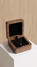 Walnut necklace box with open lid, black velvet insert, pendant necklace resting inside