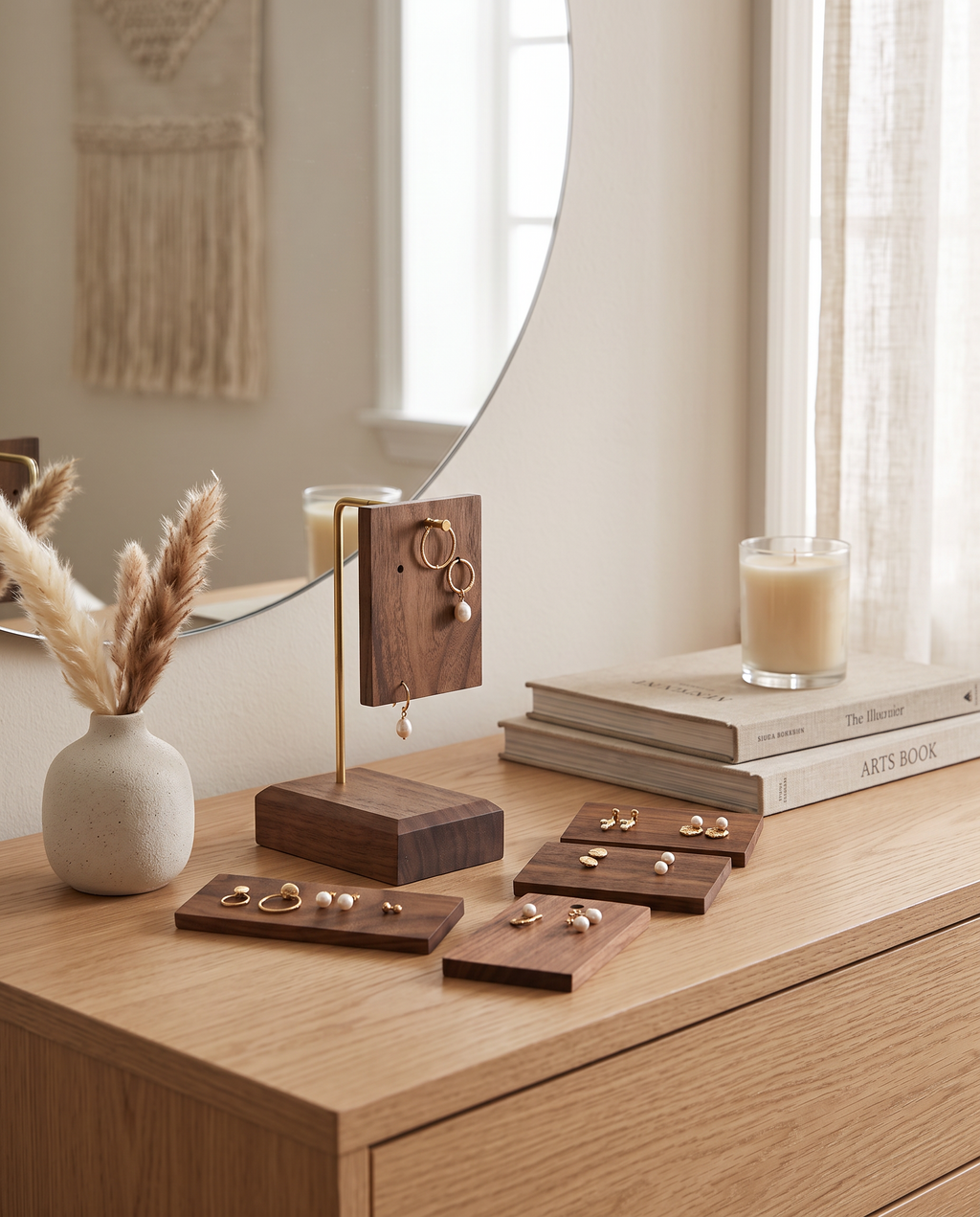 Walnut earring display stand with small accessory trays on a wooden surface