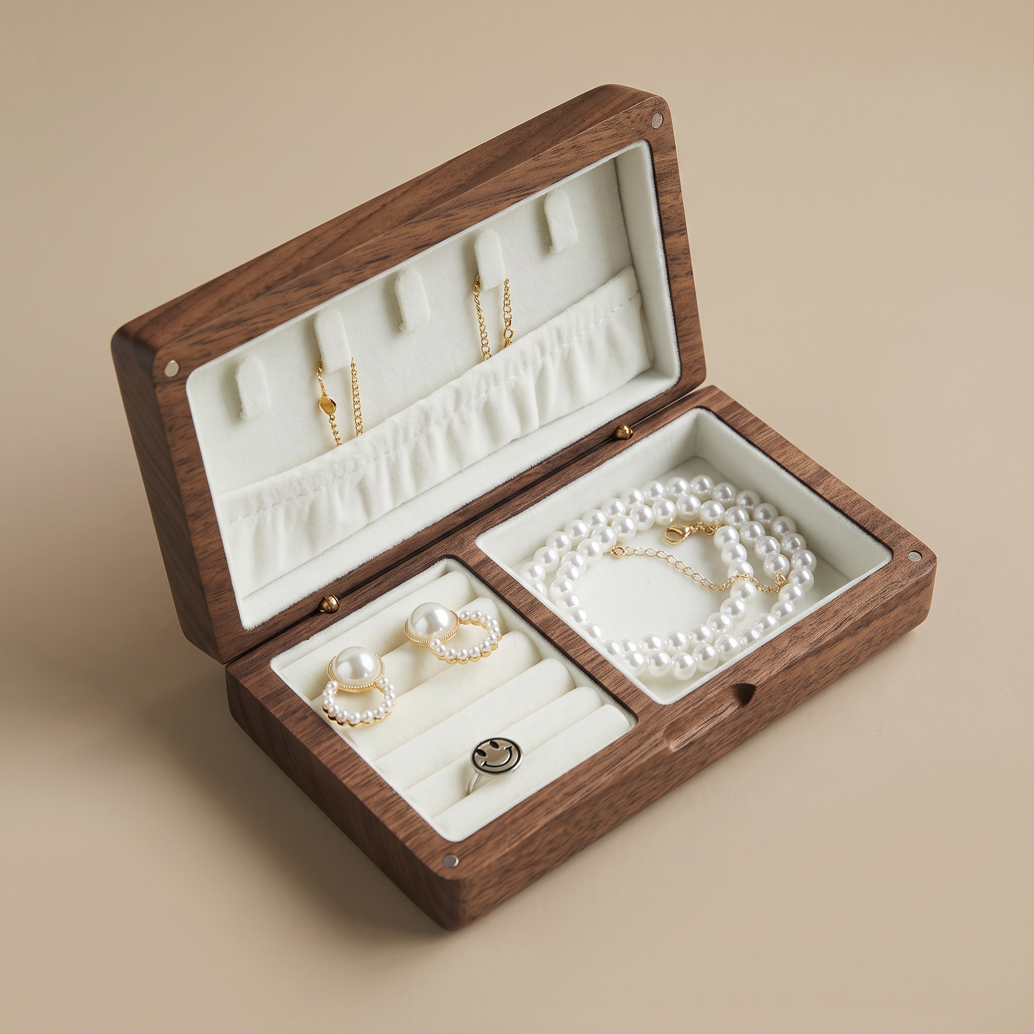 Walnut jewelry box open with white velvet insert and pearl necklace and earring sections.