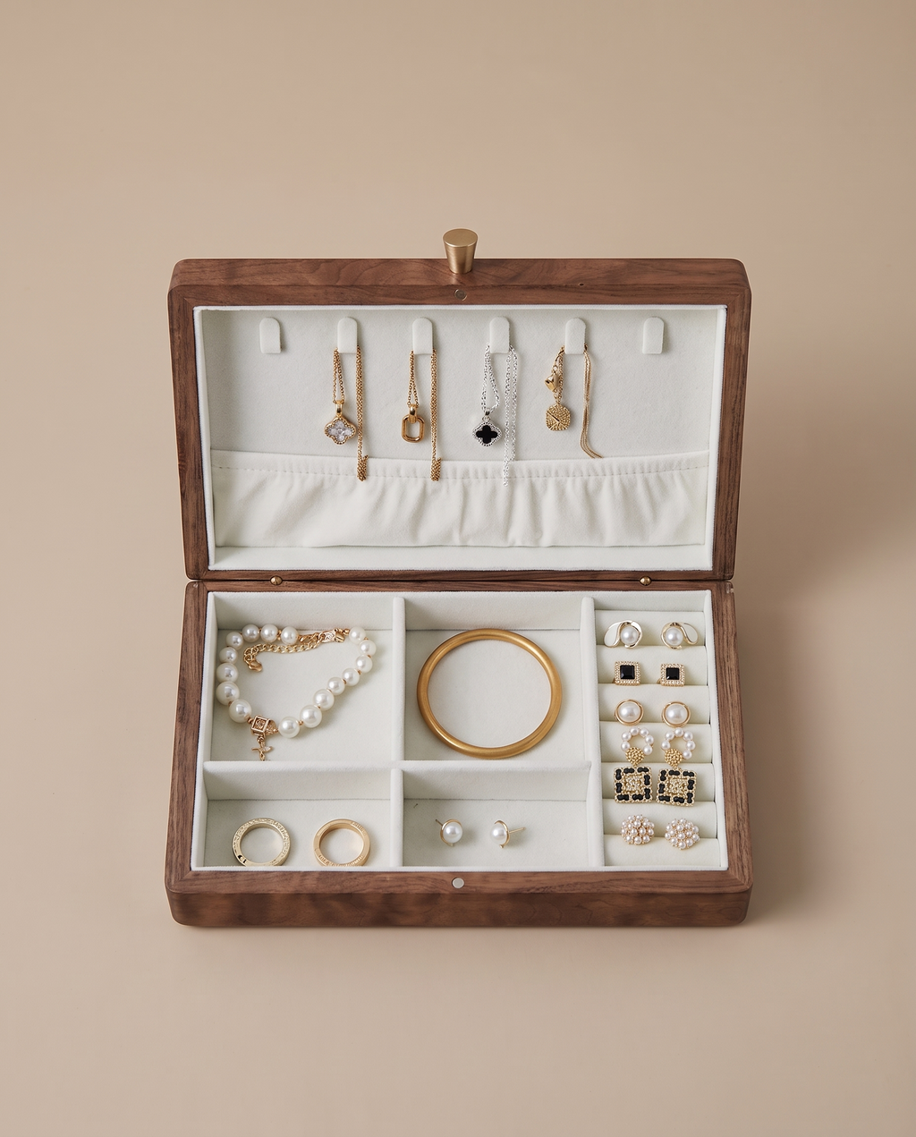 Walnut jewelry box with white velvet organizer and multiple ring and necklace compartments.