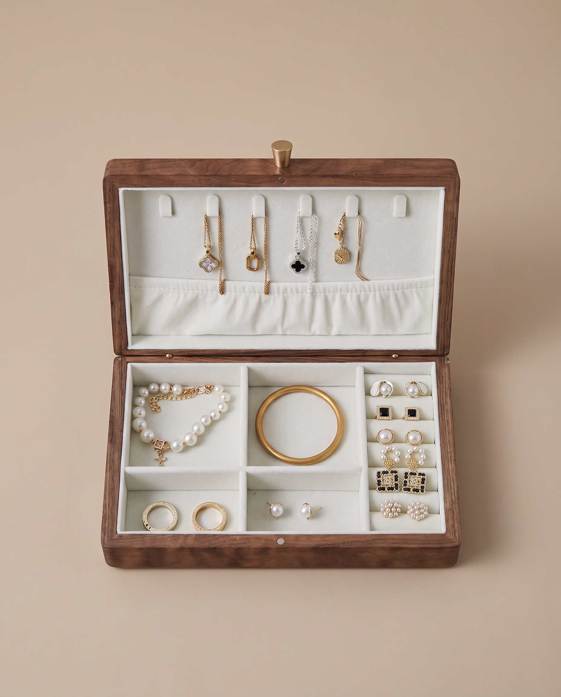 Walnut jewelry box with white velvet organizer and multiple ring and necklace compartments.