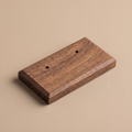 Walnut earring display board with two drilled holes on top surface