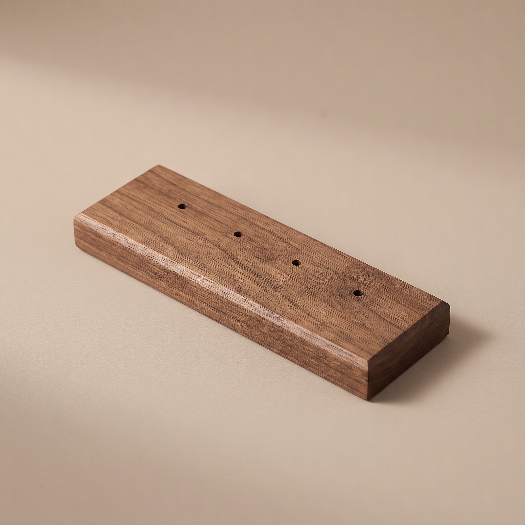 Walnut earring display board with four drilled holes in a row