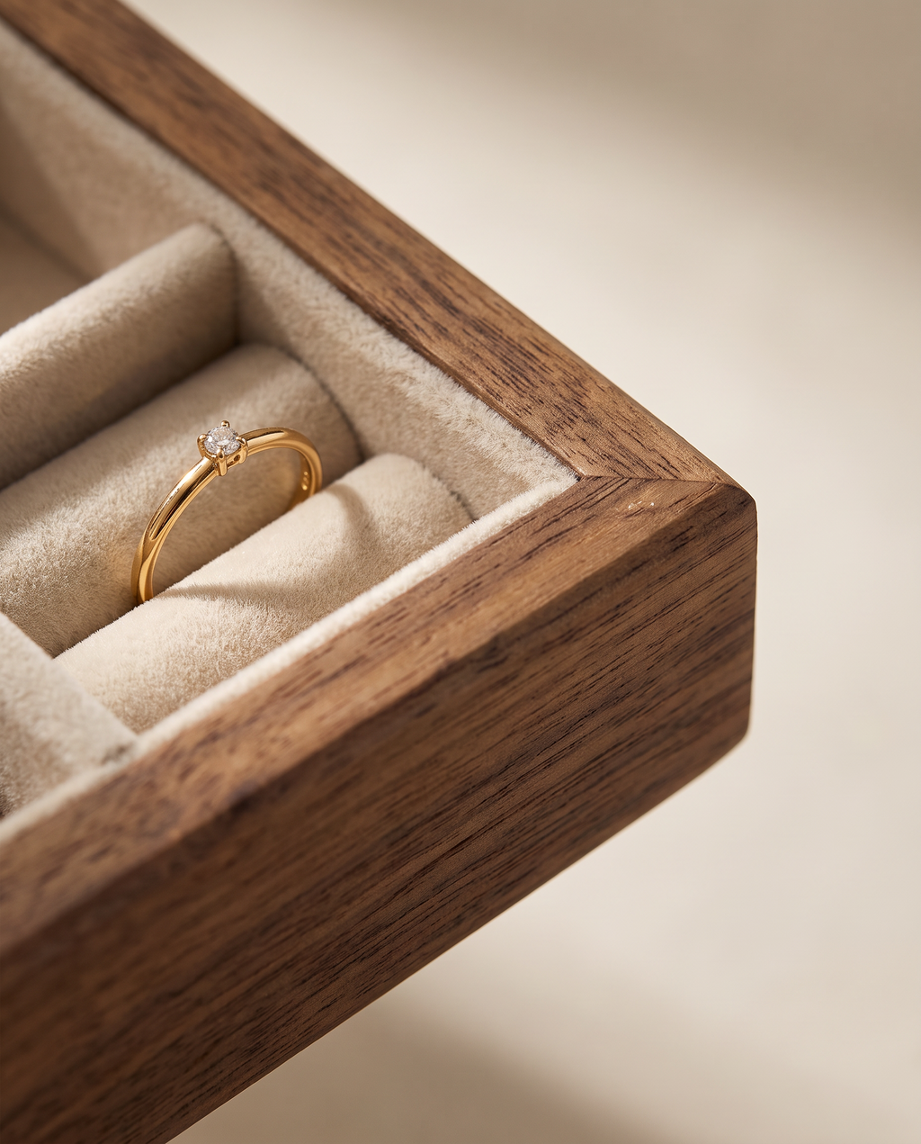 Walnut jewelry tray corner detail with velvet-lined ring slot and gold ring