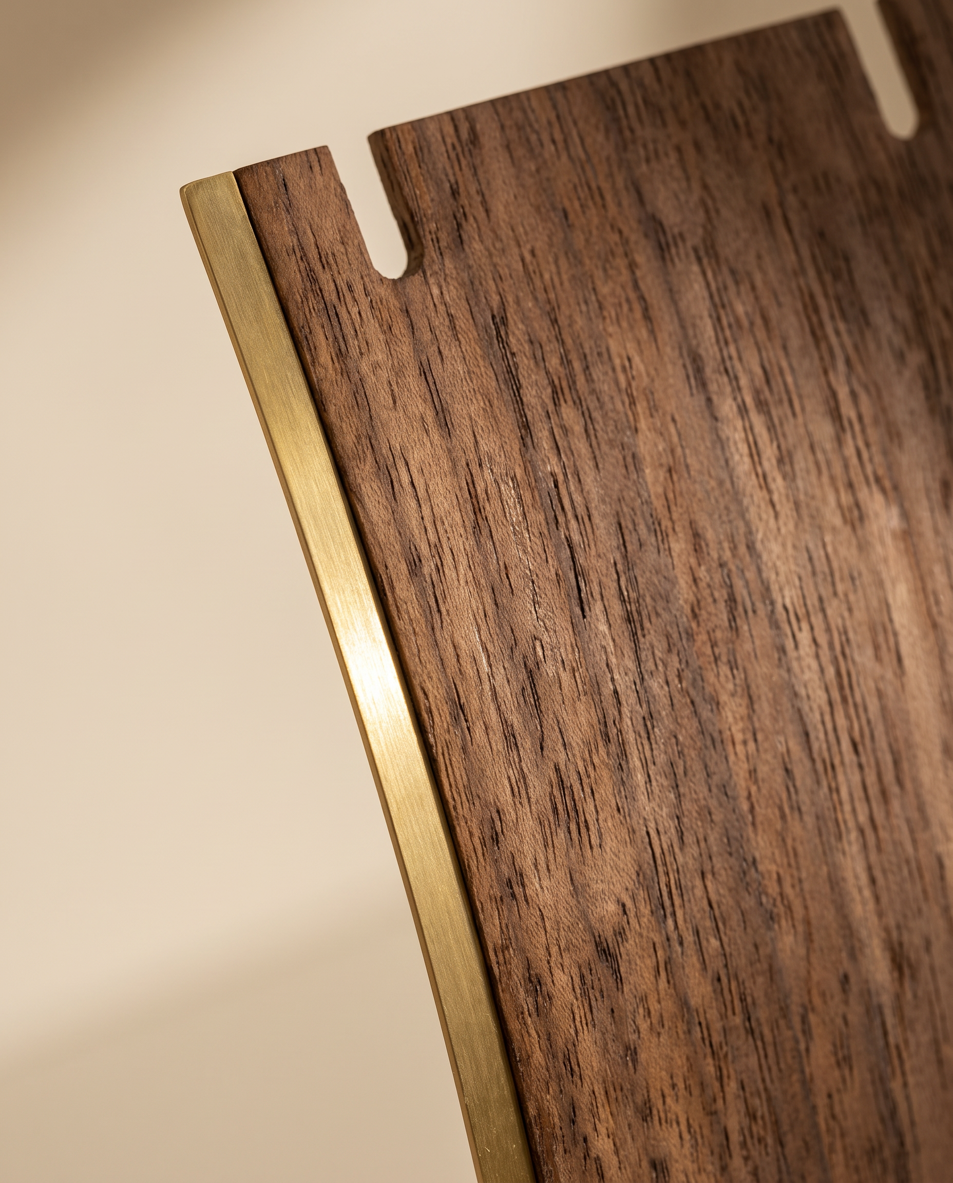 Walnut necklace display stand detail: wood panel cutout with gold-toned edge