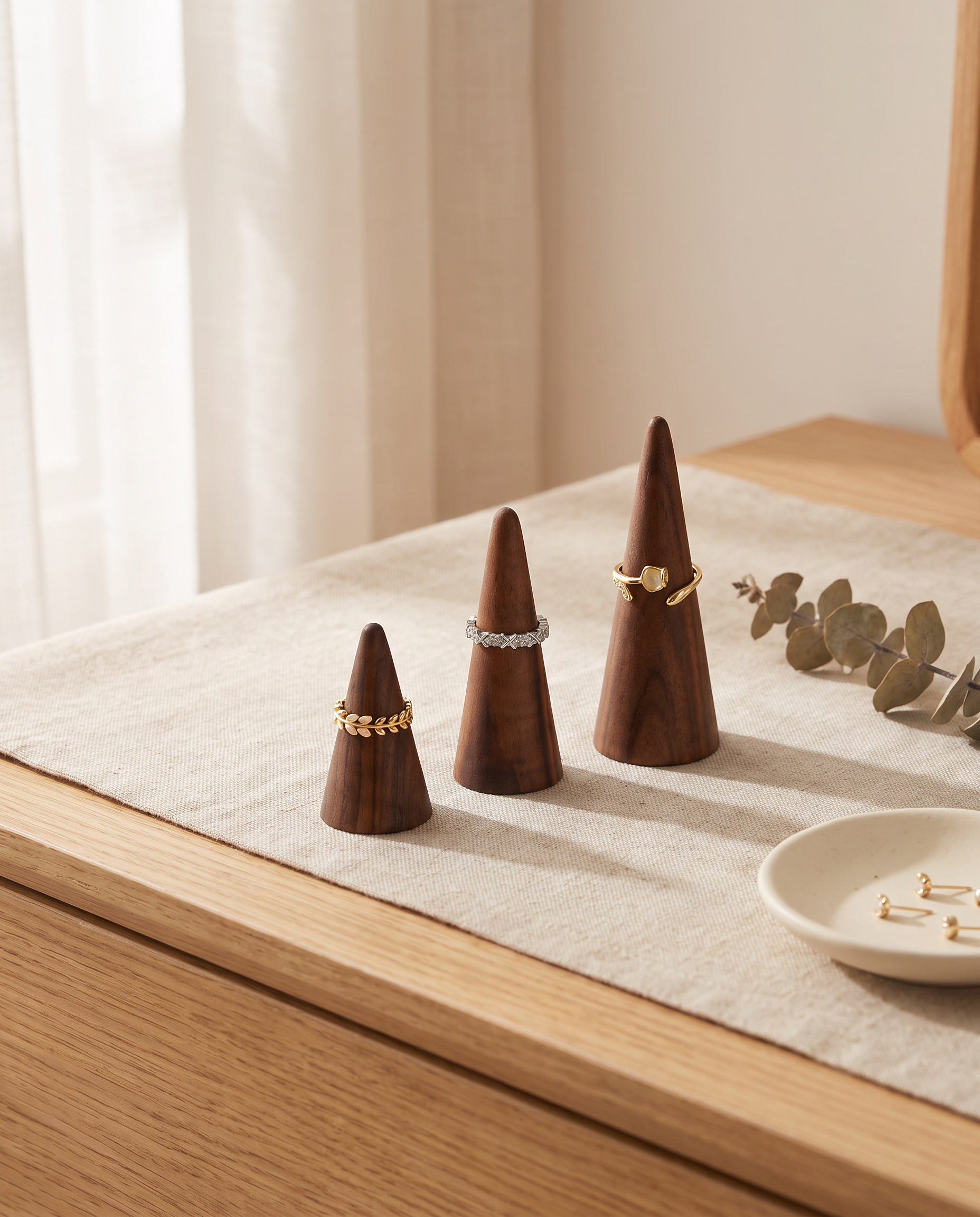 Walnut ring cone holder set with three conical stands and gold-tone stacking rings