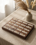 Walnut ring display tray with 20 velvet slots and metal rings on white inserts