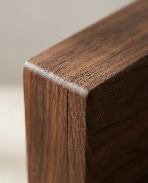 Wood jewelry box corner with smooth finish and rounded edge, dark brown