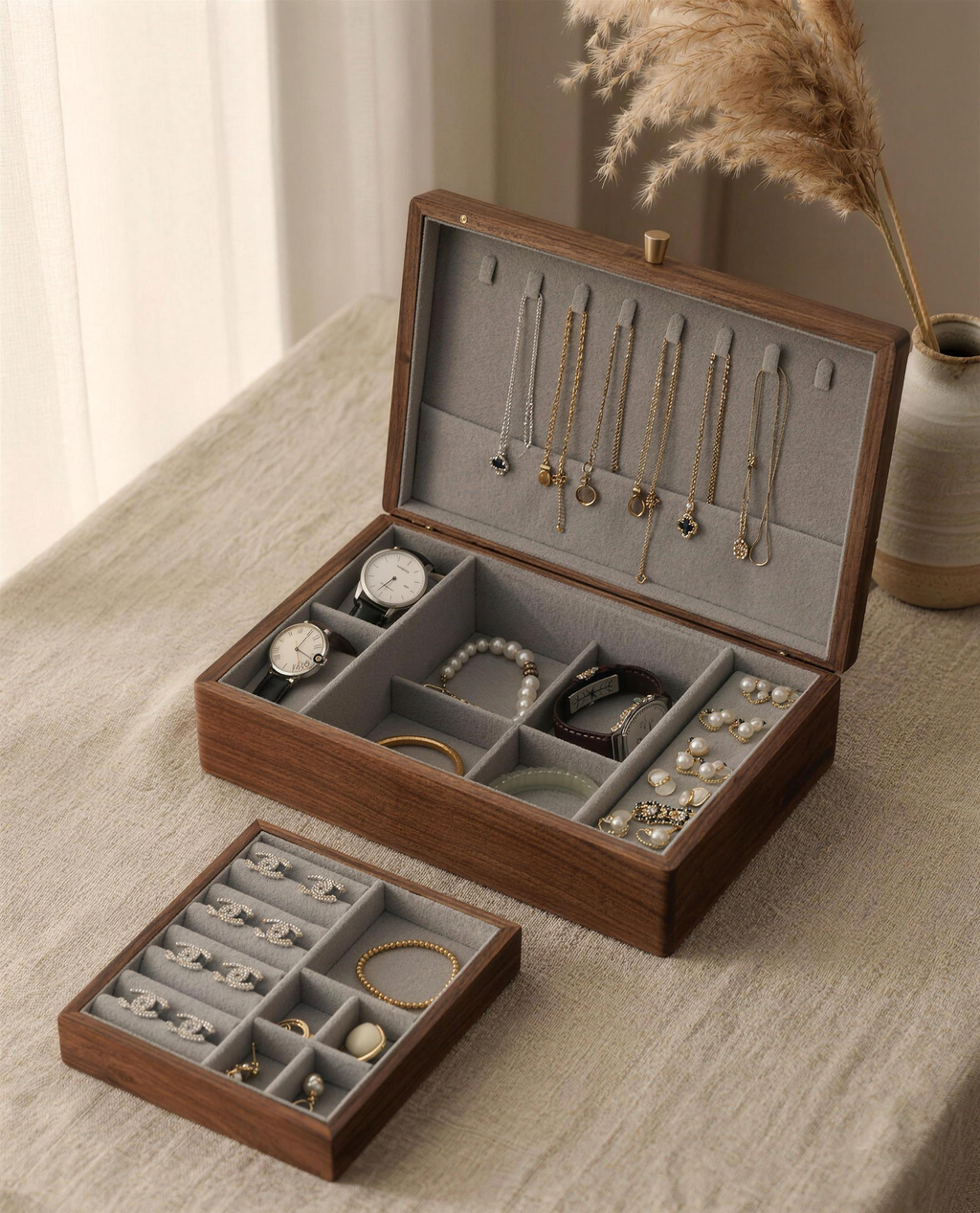 Walnut jewelry box with gray fabric lining, open with trays and necklace hooks visible.