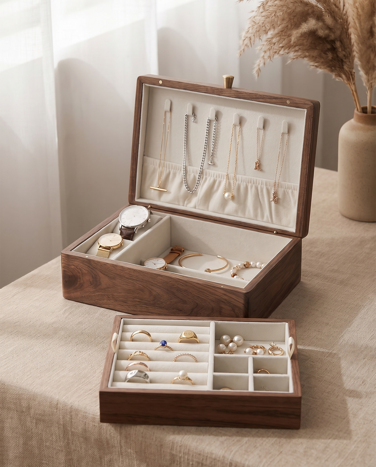 Medium walnut jewelry box filled: four necklaces hanging from lid hooks, lift-out tray with rings and earrings, watches and bracelets in the lower section