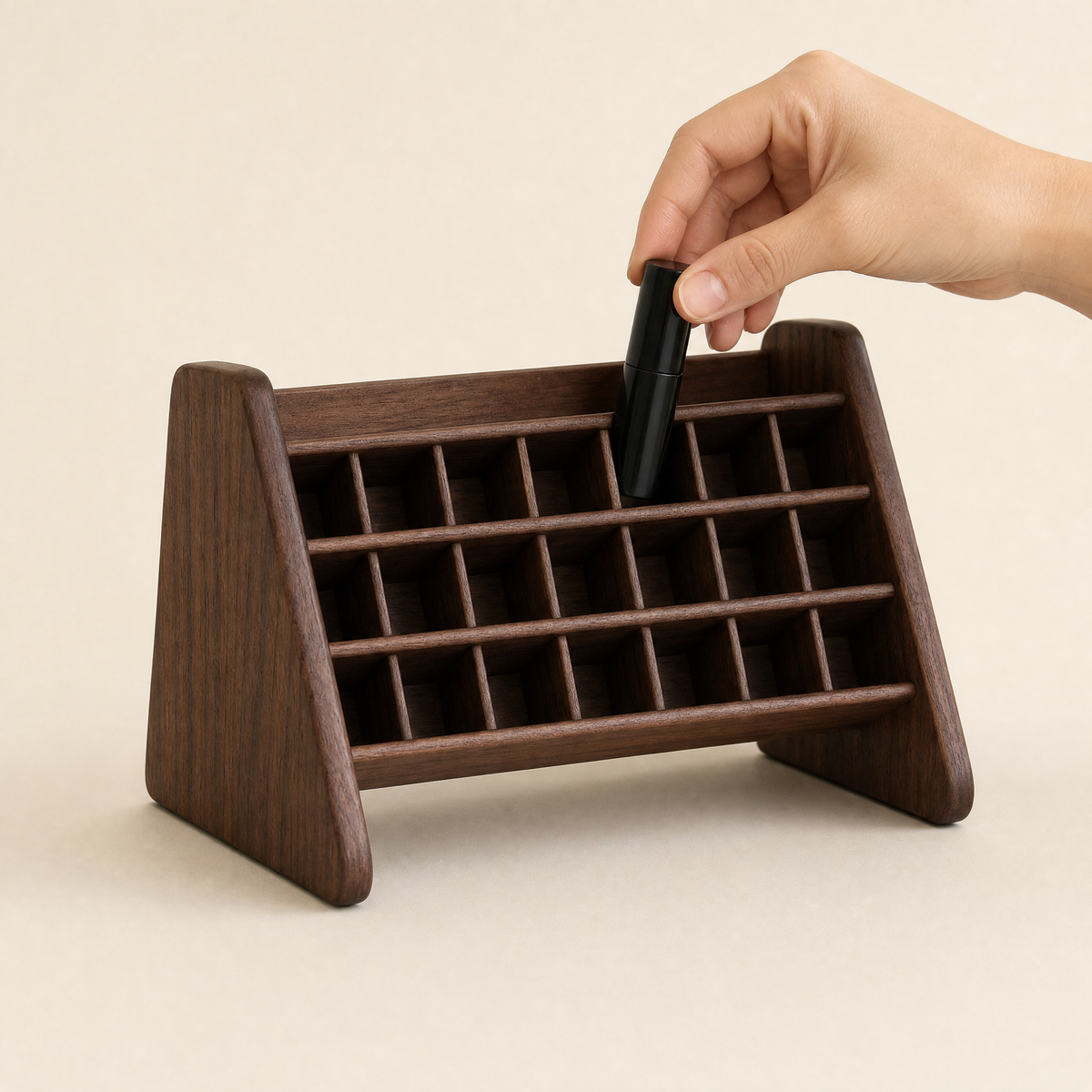 Walnut lipstick organizer stand with hand placing a lipstick into a slot