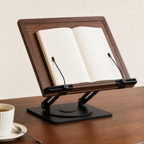 Walnut book stand holding an open book with adjustable side pins on a rotating base.
