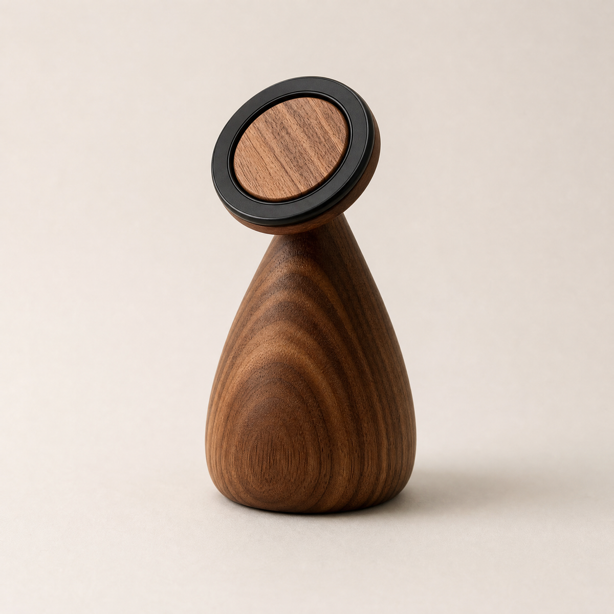 Walnut phone stand with black circular top and teardrop base, 360° rotation