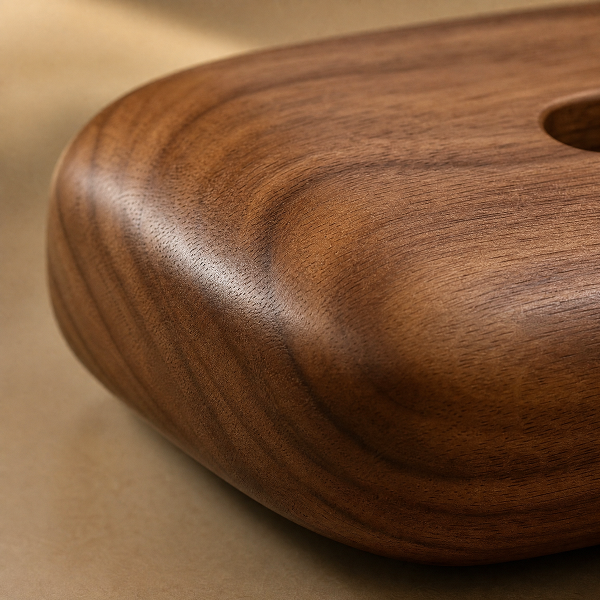 Close-up of walnut wood tissue box cover with visible grain and rounded edge