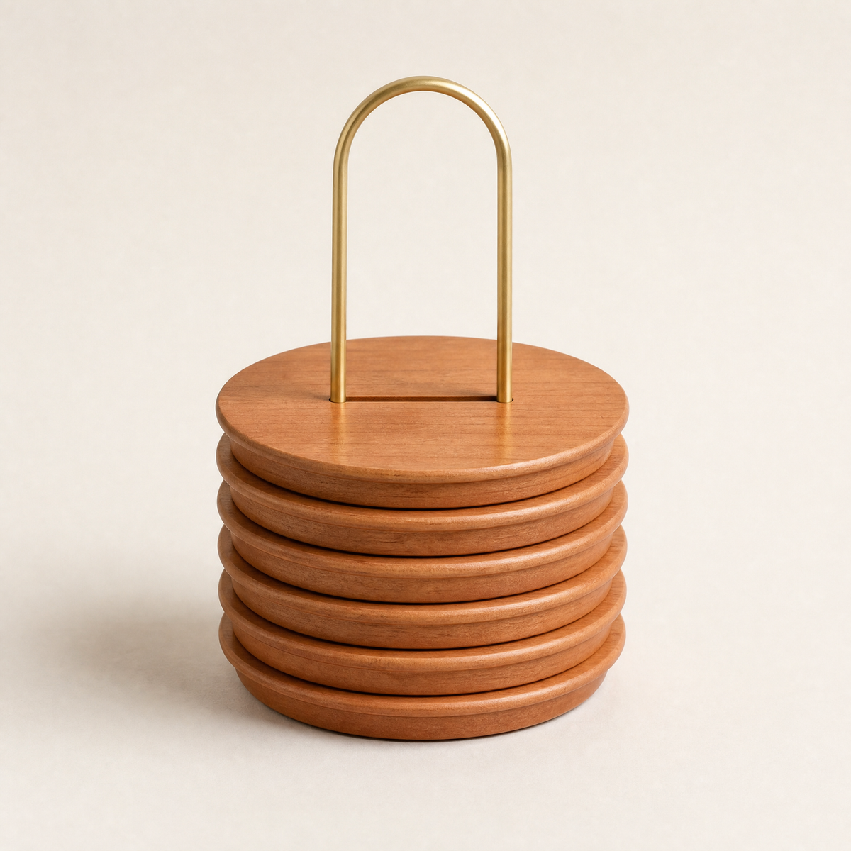Stacked round cherry trivets with brass carry handle, set of six.
