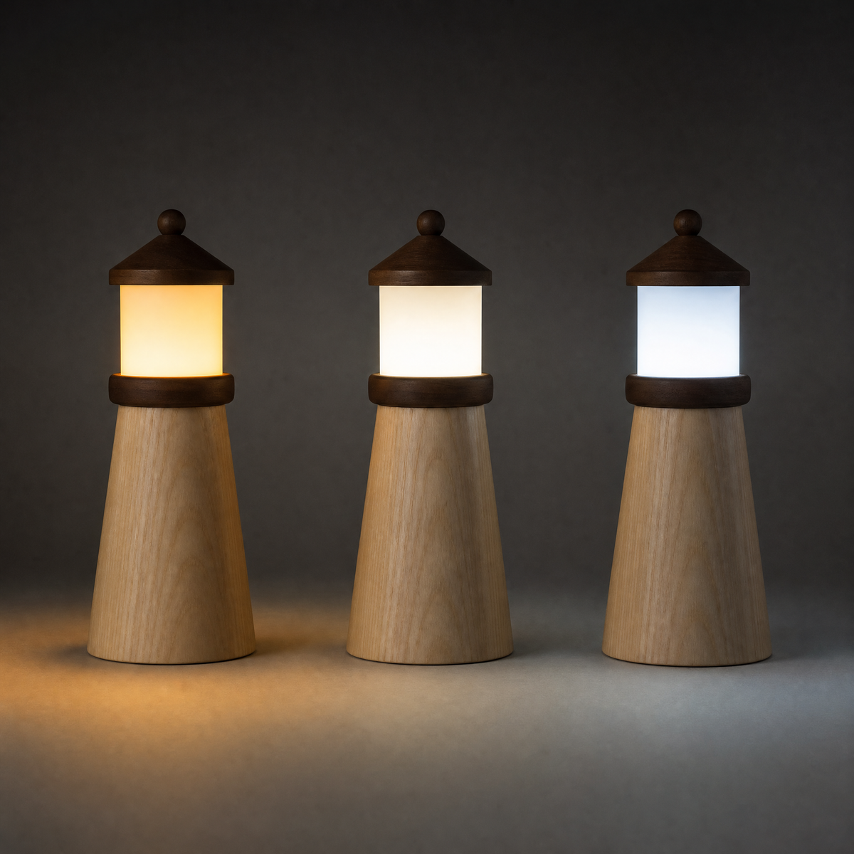 Set of three wooden lighthouse night lights with warm, neutral, and cool glow
