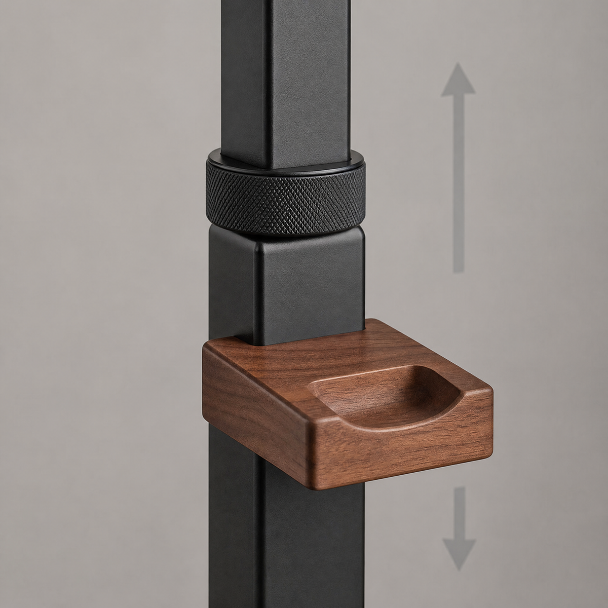 Height-adjustable stand close-up: textured dial and walnut controller arm on black post