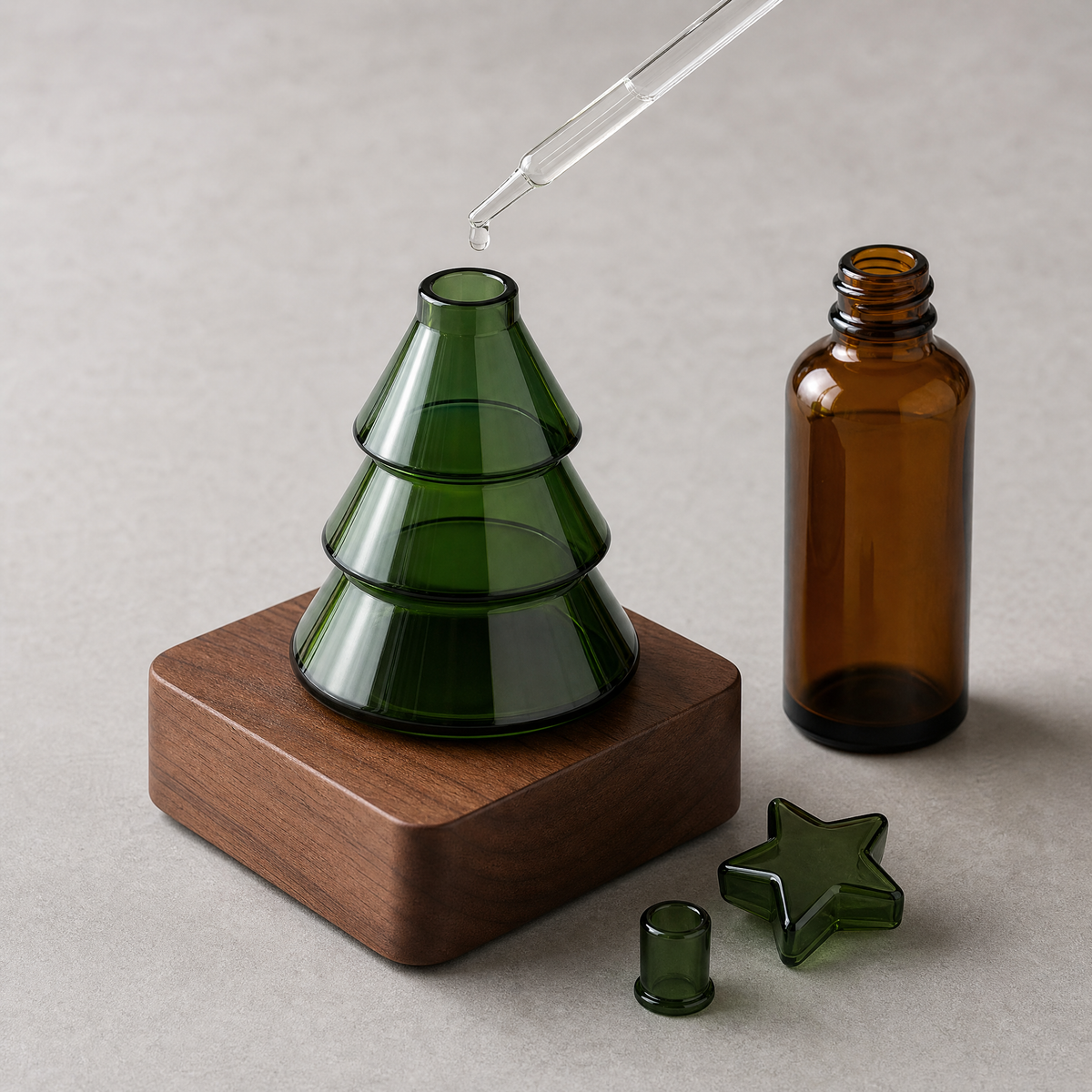 Christmas tree diffuser base with green glass bottle, star piece, and dropper