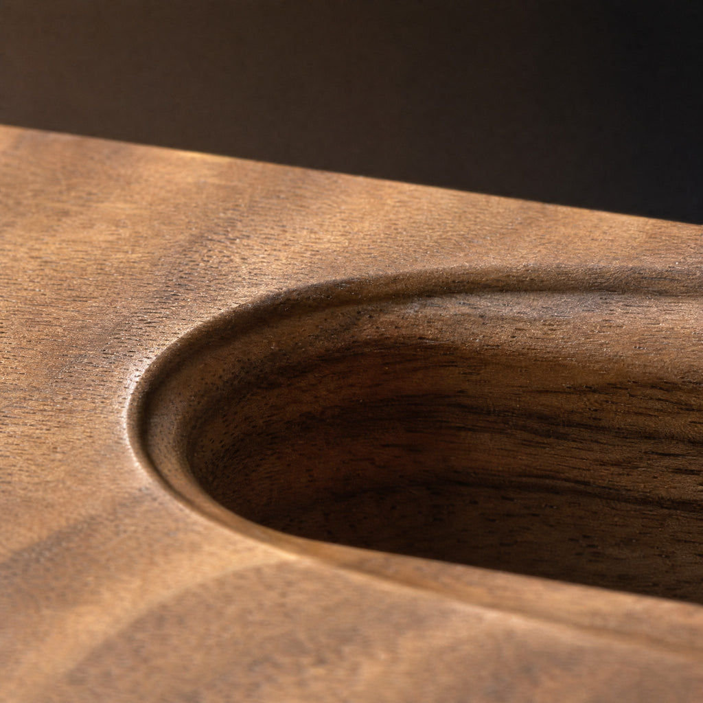 Macro of the chamfered rounded end of the slot and the open walnut grain