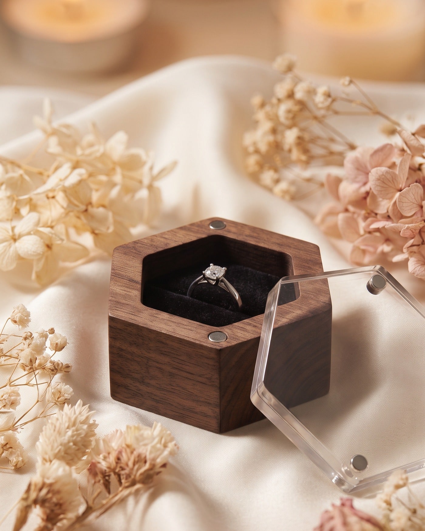 Walnut ring box with clear acrylic lid, open view showing two rings on dark velvet