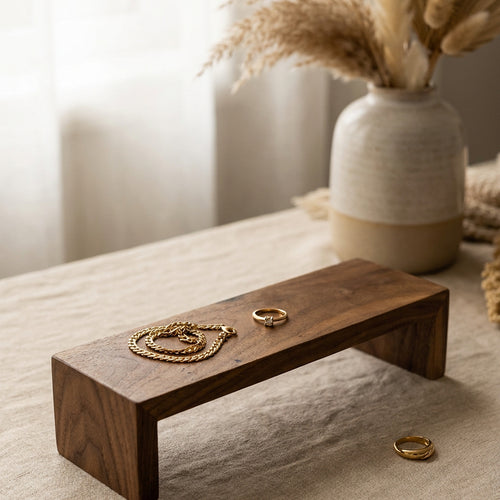 Solid walnut display riser stand with jewelry on a linen runner