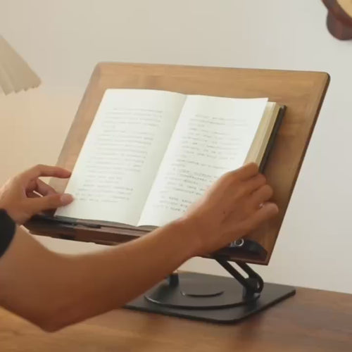 Walnut book stand on its 360-degree base: pages turned, page clips adjusted, panel tilted and the stand rotated