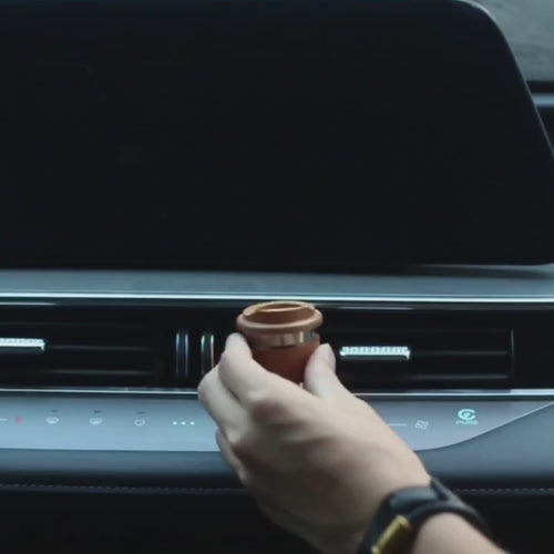 Cherry wood diffuser cup clipped to a car air vent: lift the lid, add oil, close it