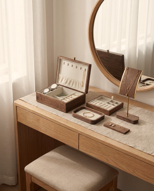 Wood jewelry organizer set on vanity: open box, necklace stand, tray and earring board